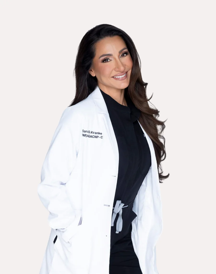 Sara Kranke, DNP, AGACNP-C, APRN, in her white coat